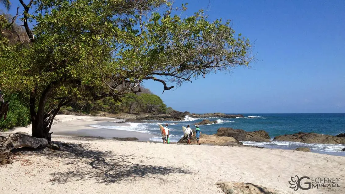 Surfers in the water off the Montezuma coast